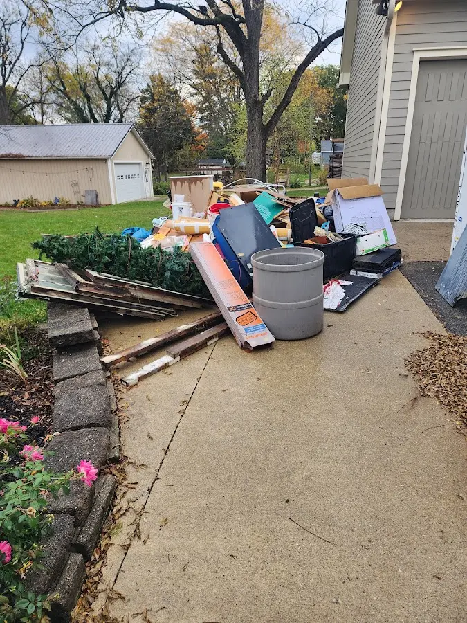 Dumpster being loaded with debris for 3 Yard Dumpster Rental in Burnsville